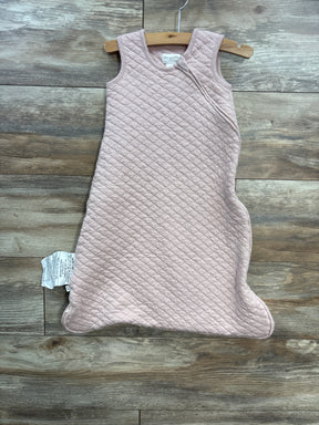 Light pink quilted baby sleeping sack on wooden floor with shoulder snaps and side zipper