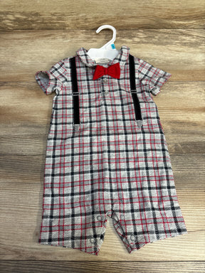 Front view of grey plaid baby romper 3–6m with red bow tie, black faux suspenders, short sleeves, snaps at legs on wood