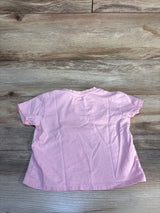 Light pink short sleeve toddler t-shirt on wood background, gently used kids clothing