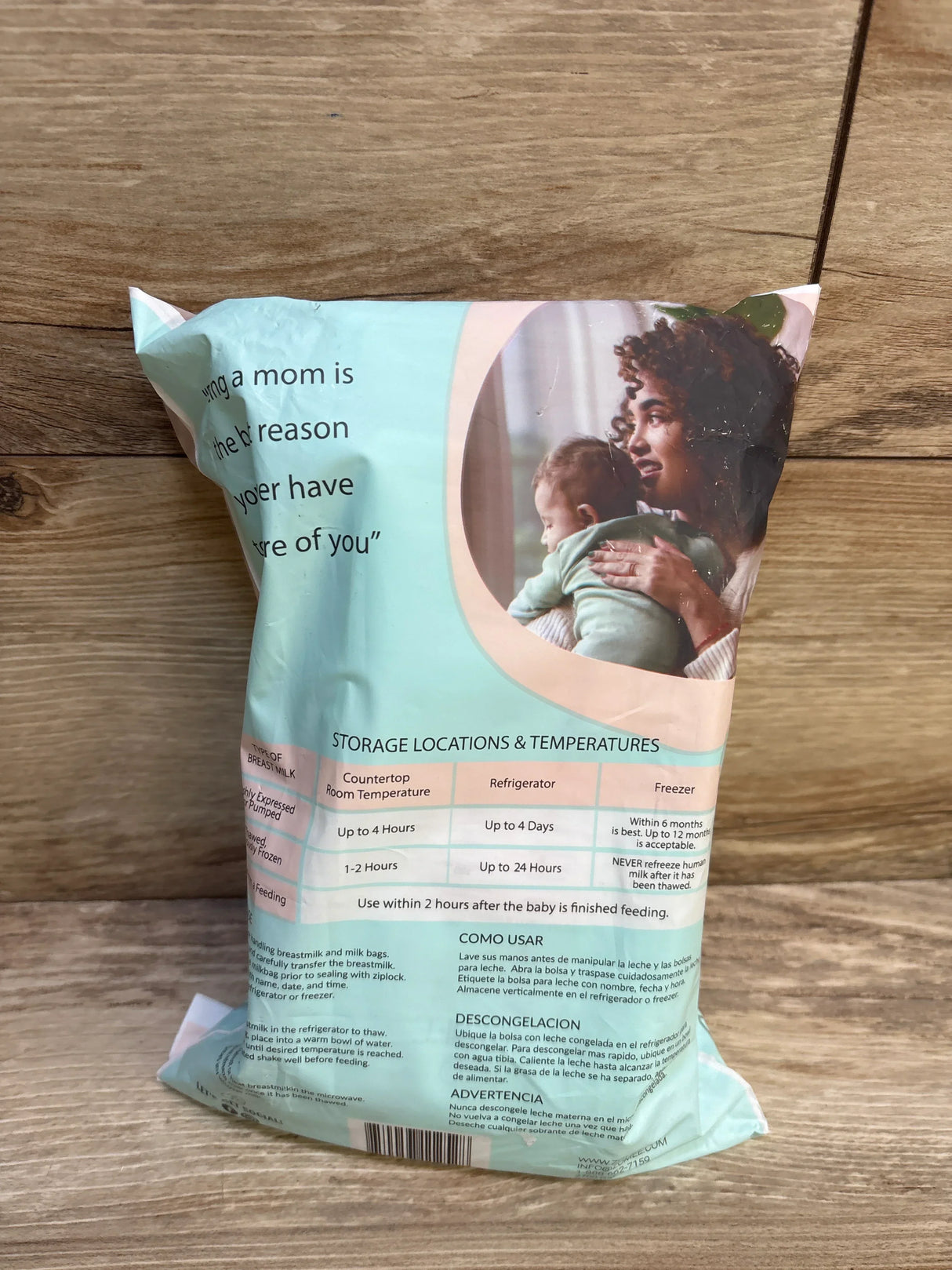 Breast milk storage bag with temperature guidelines, woman holding baby, on wood surface