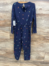 Old Navy navy blue long-sleeve kids jumpsuit with multicolored heart prints hanging on wooden wall