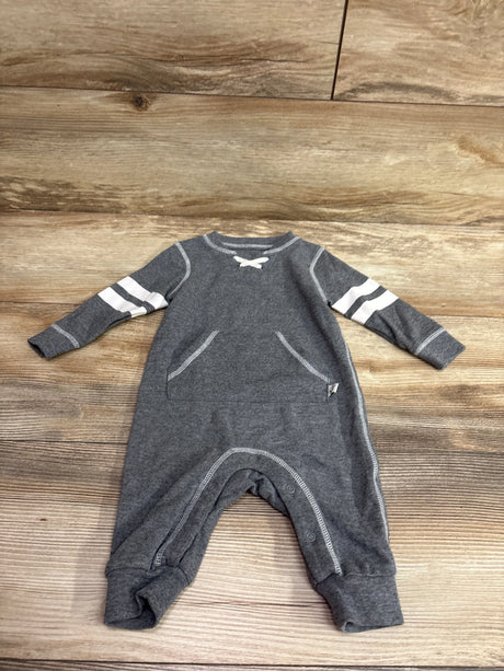 Grey Mini Heroes baby coverall size 6m with white sleeve stripes on a wooden background