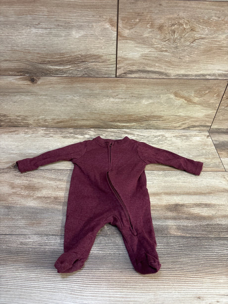 Flat lay of newborn Old Navy footed sleeper showcasing diagonal front zipper and long sleeves with wood plank background