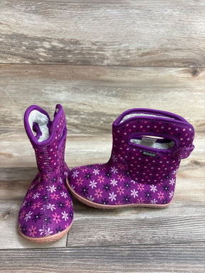 Purple Bogs toddler boots with pink flower and polka dot pattern on wood floor