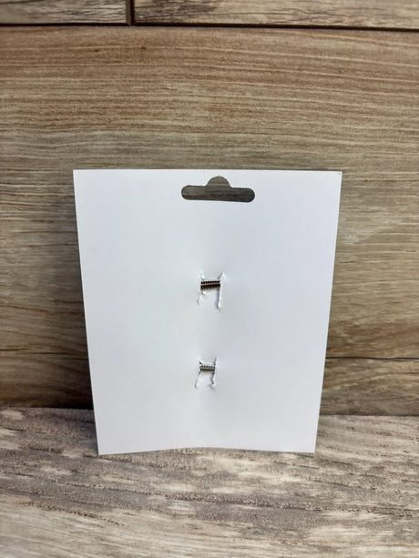 Front view of two hair bow clips on a white display card showcasing metal alligator closures against a wood-grain surface