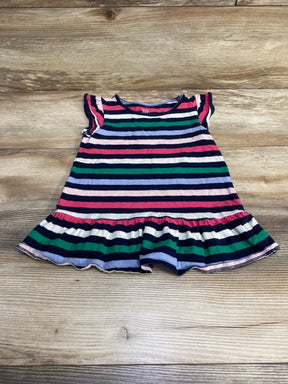 Flat-lay of Baby Gap striped peplum toddler shirt (navy multicolor) showcasing ruffled hem and cap sleeves on wood background