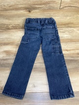 Dark denim kids jeans with elastic waistband and back pockets on wood floor