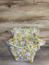 Flat lay of Carter's green floral skirted bodysuit showing short sleeves, peplum skirt, and snap closures on wood background