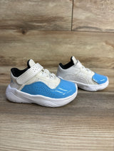 Blue and white toddler sneakers with Velcro straps on wooden floor
