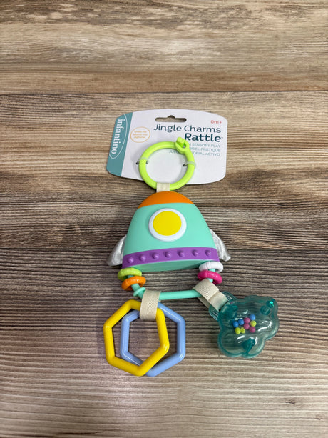 Front view of Infantino Jingle Charms Rattle Toy showcasing colorful rings, beads, and textured surfaces on a wood grain background