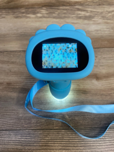 Blue kids digital microscope toy with screen and strap on wood surface