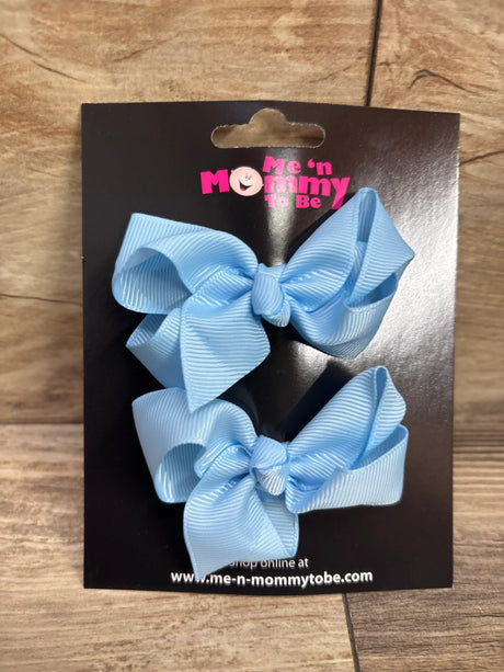 Two light blue grosgrain hair bows on Me n Mommy To Be packaging.