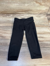 Black toddler leggings with pockets on a wood floor, gently used kids clothing
