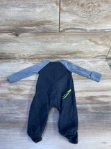 Back flat lay of Nike grey baby sleeper showing light-gray raglan sleeves and neon green stripe detail on wood plank background