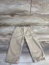 Front flat lay of Baby Gap 2T khaki chinos showing slim fit, button waist and belt loops on wood background