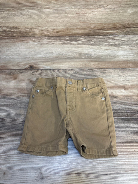 Brown toddler shorts with pockets displayed on wooden background