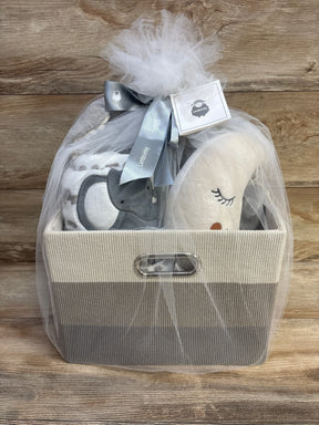 Front view of Lambs and Ivy gray 5-piece gift basket showing plush moon, gray elephant, blanket, and tulle bow on wood