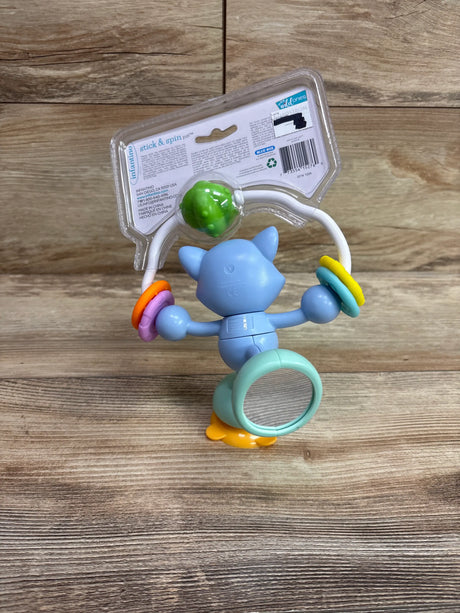 View of Infantino Stick and Spin Raccoon Pal suction toy showcasing colorful rings, green ball, and suction base in packaging