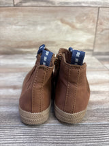 Rear view of Cat & Jack zipper boots, size 8C, showing navy pull tabs and textured tan rubber soles on wood floor
