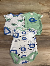 Assorted baby onesies with animal prints, featuring lions and tigers on wood background.