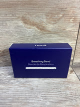 Front package view of NEW Nanit Breathing Band size 0-3m showcasing navy blue box labeled 6-12.5 lb on wood plank backdrop
