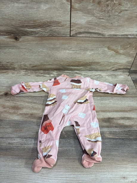 Pink Honest Baby newborn sleeper featuring a s'mores print on a wooden background.