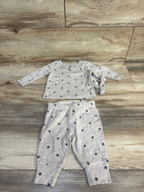 Gray polka dot baby outfit with long sleeves and pants on wooden floor