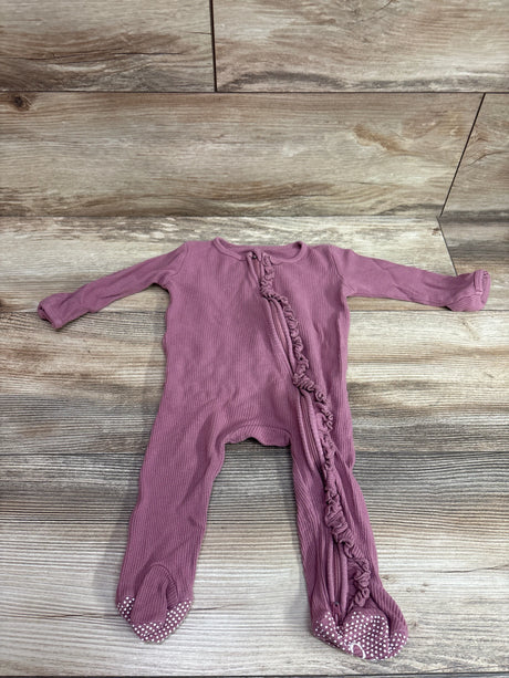 Front view of pink bamboo knit ruffle zipper footie showcasing its ruffled zipper and covered feet on wood flooring