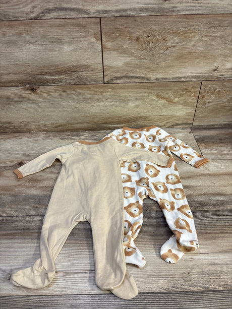 Top view of Little Beginnings 2pk tan sleepers, one solid and one bear print, with footed long sleeves on wood flooring