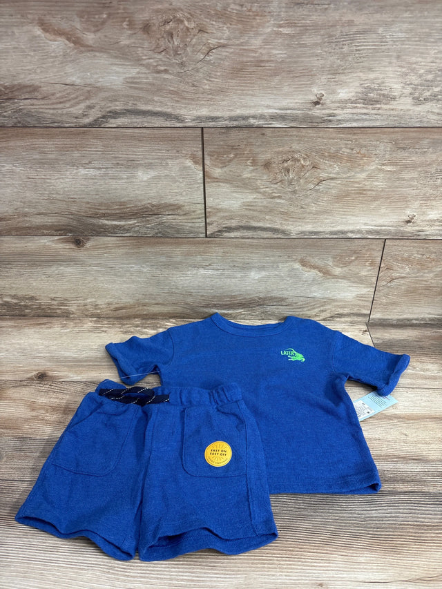 Flat lay of blue French terry toddler shirt and shorts set (2T) showing Later gator print and drawstring shorts on wood floor