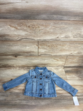 Light blue denim jacket for kids with button front and flap chest pockets on wood background