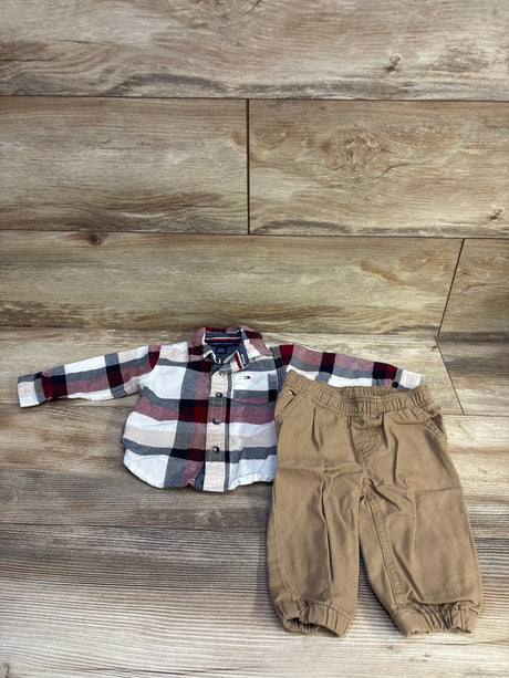 Front view of Tommy Hilfiger 2-piece baby button-up plaid shirt and tan elastic-waist pants, size 3-6 months, on wooden background