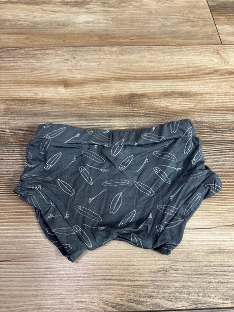 Top view of gray Kahakai bamboo bummies for ages 6 to 12 months, with white surfboard print and elastic waistband on a wood floor