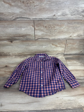 Kids long sleeve blue and red plaid button-up shirt on wood background