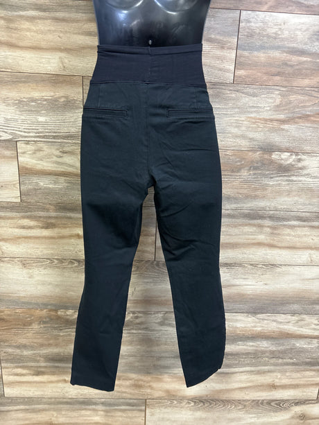 Front view of Old Navy Maternity Pixie full-panel pants showing high belly panel and slim ankle-length legs on wood floor