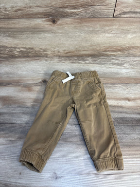 Toddler khaki pants with elastic waistband and drawstring on wood background