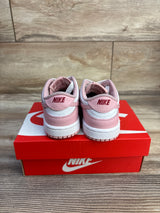 Rear view of toddler Nike Dunk Low Pink Glaze sneakers with pink and white leather, red NIKE heel logo on red box