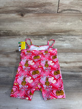 Flat lay of pink Shein x Scooby-Doo shortie romper size 12-18M showing heart and Scooby-Doo print, thin shoulder straps, and original tag on wood floor