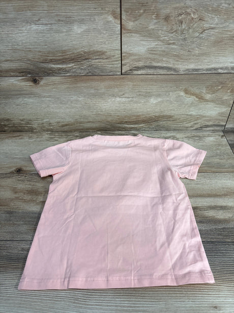 Back view of plain light pink short-sleeve toddler t-shirt on wooden floor