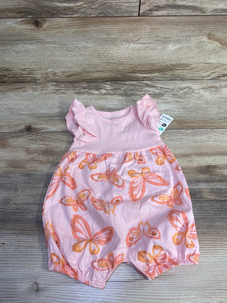 Flat-lay of Just One You butterfly sleeveless shortie romper size 6M showing ruffle shoulder sleeves, snap leg closures, and orange butterfly print on wood background