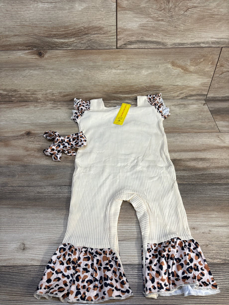 Toddler cream ribbed romper with leopard ruffle sleeves, matching headband on wood floor