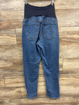 Back view of Old Navy maternity boyfriend jeans showcasing blue denim, full panel, and back pockets on a wood floor
