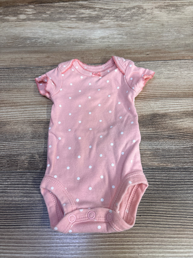 Flat lay front view of Simple Joys pink preemie polka dot bodysuit showing short sleeves and three-snap crotch on wood surface