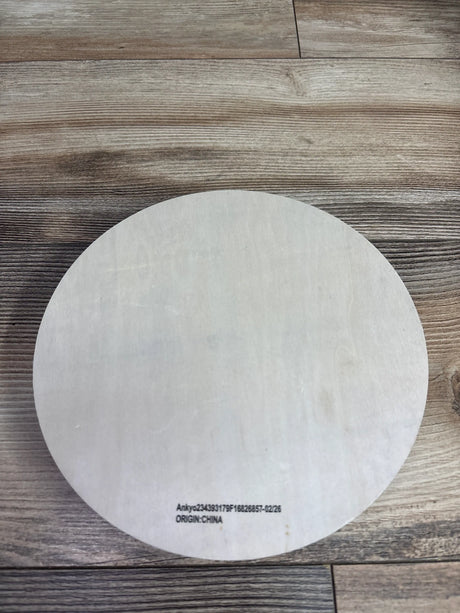 Back view of Bullseye’s Playground wooden sliding maze showcasing its round white backing on a wood-grain surface