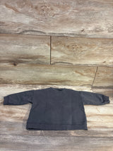 Back view of Zara Explore Now grey sweatshirt for ages 3 to 6 months, showcasing ribbed cuffs and hem on a wood surface
