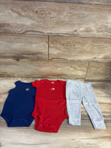 Top view of Carter’s 3-piece Home Run bodysuit set, size 12m, with navy and red bodysuits, gray pants, and wood floor