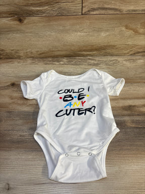 White baby onesie with colorful text 'Could I BE any cuter?' on wood floor background