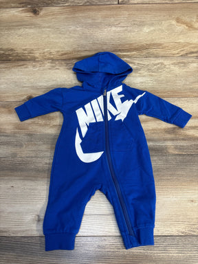 Blue hooded baby romper with front zipper and white graphic on wooden background