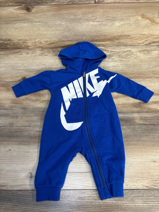 Blue hooded baby romper with front zipper and white graphic on wooden background
