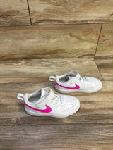 Front-quarter view of toddler Nike Court Borough Low Recraft sneakers showing white leather upper and bright laser fuchsia Swoosh on wood floor